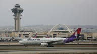 Hawaiian Airlines flight declares emergency after a mobile device gets stuck in seat, emits 'electrical smell'